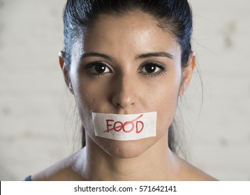 Close Up Face Of Young Beautiful Sad Latin Woman With Mouth Sealed On Stick Tape With The Text No Food And Concept Of Refusing Eating And Overweigh In Anorexia Bulimia And Nutrition Disorder Concept 