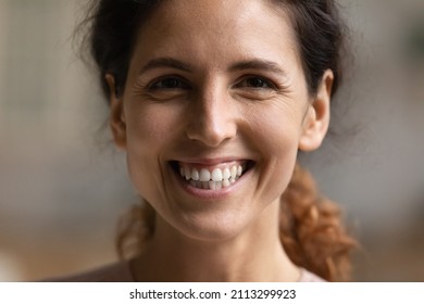 Close up face young Hispanic woman smile look at camera pose alone indoor. Professional occupation person, counsellor, teacher portrait. Beauty treatment ad, dentistry services clinic client concept