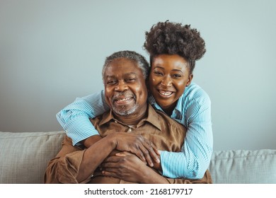 Close up faces of elderly 80s grandfather adult 30s granddaughter. Teenager girl sitting on window with father. Beautiful African American woman with her father as they both smile - Powered by Shutterstock