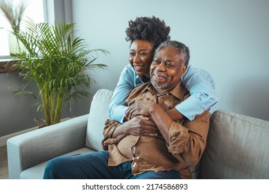 Close up faces of elderly 80s grandfather adult 30s granddaughter. Teenager girl sitting on window with father. Beautiful African American woman with her father as they both smile - Powered by Shutterstock