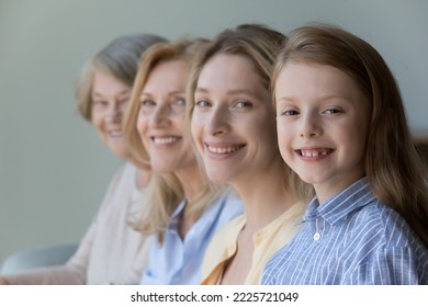 Close up faces in row, diverse women smile looking at camera, little cute girl, her adult mother, mature grandmother and old great-grandmother portraits. Multi-generational family, heredity, offspring - Powered by Shutterstock