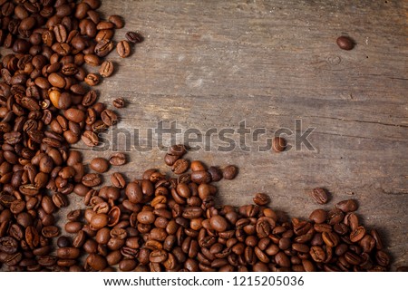 Close up of fair trade coffee beans on old wooden desk