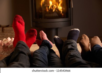 Close Up Of Familys Feet Relaxing By Cosy Log Fire With Marshmallows