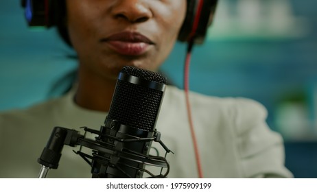 Close up of famous woman recording a vlog for subscribers using podcast microphone for vlogging. On-air online production internet broadcast show host streaming live content for social media - Powered by Shutterstock