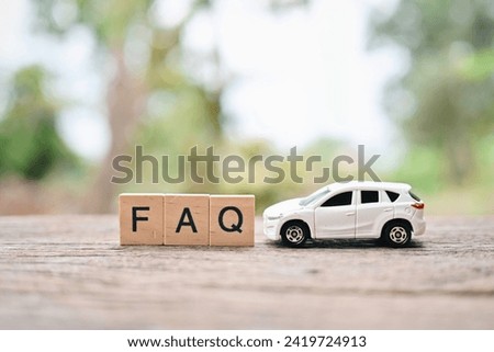 close up FAQ wooden text block and toy car on wood table, Frequently Asked Questions