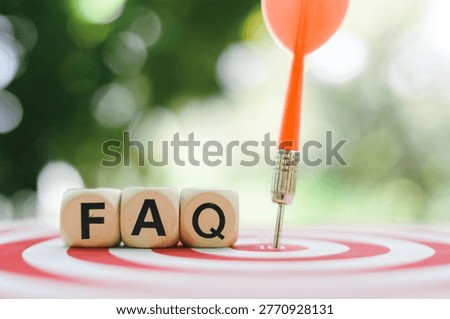 close up FAQ wooden text block on dartboard, Frequently Asked Questions