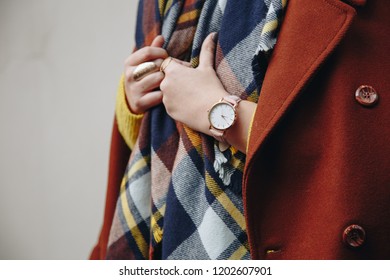 Close Up Fashion Details, Fashionable Woman Wearing A Oversized Coat, Check Scarf, A Golden Watch And Gold Rings, Ideal Fall Outfit Accessories.
