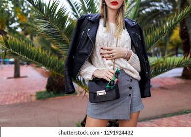 Close Up Fashion Details, Trendy Stylish Woman Posing On The Street Near Palm Trees, Mini Skirt, Sweater, Cross Body Bag, White Sweater, Leather Jacket, Jewelry And Accessories,modern Street Style