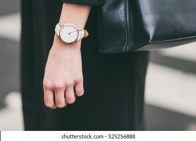 Close Up Fashion Details, Young Business Woman Holding Her Black Elegant Bag. Wearing Golden And White Watch. Ideal Fall Outfit Accessories.

