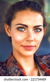 Close Up Fashion Portrait Of Beautiful Woman With Perfect Glowing Skin Big Green Eyes And Natural Make Up, Wearing Bright Shirt, Looking On Camera. 
