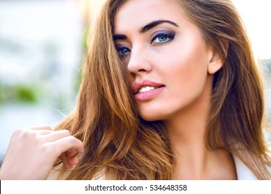 Close Up Fashionable Portrait Of Attractive Sensual Sexy Woman Touching Her Hair. Magnificent Smile, Elegant Make-up, Blonde Long Hairstyle, Big Beautiful Eyes, Full Lips.