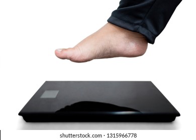 Close Up Of Fat Man Feet Stepping On The Weighing Scale, Isolated On White Background