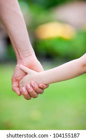 Close Up Of Father Holding His Daughter Hand