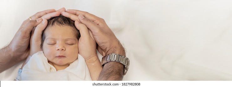 Close up father and mother hands holding newborn baby, copy space background banner family parents love concept
