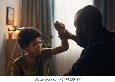 Close up of father and son fighting with dramatic lighting copy space - Powered by Shutterstock