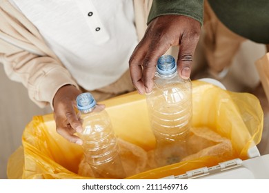 Close up of father and son sorting household waste at home together, copy space - Powered by Shutterstock