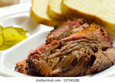 Close Up Of A Fatty Barbecue Brisket Picnic Plate, Including White Bread And Pickles.