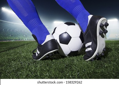 Close up of feet kicking the soccer ball