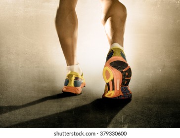 close up  feet with running shoes and strong athletic legs of sport man jogging in fitness training workout isolated on grunge harsh background design in advertising poster style - Shutterstock ID 379330600