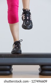 Close Up Of Feet In Step Equipment At Gym