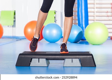 Close Up Of Feet In Step Equipment At Gym.