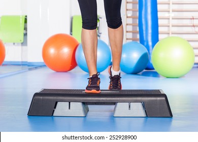 Close Up Of Feet In Step Equipment At Gym.