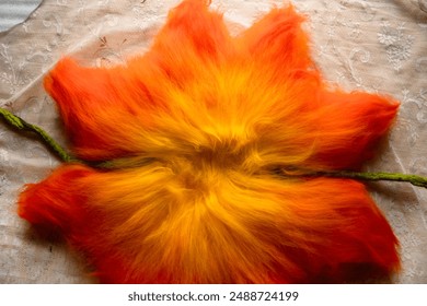 Close up of felting wool layers texture. Gradient from yellow to bright orange colors. Sheep carded wool laid out for felt project. Wet felting craft. Textile art background. Top view. Copy space. - Powered by Shutterstock