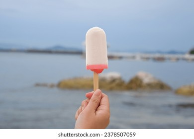 Close up of a femal hand holding ice cream 