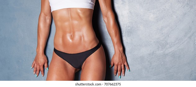  close up of female abdominal muscles - Shutterstock ID 707662375