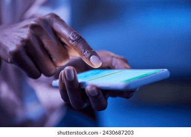 Close up of female african american hand using mobile phone in dark. Hands of black woman using smart phone during night. Woman texting on smartphone late in the evening. - Powered by Shutterstock