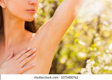 Close up of female armpit on the beautiful natural background.