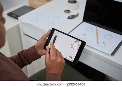 Close up of female artist using pen tablet creating new jewelry designs, copy space - Powered by Shutterstock