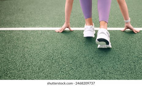 Close Up Of Female Athlete With Feet On Starting Line Before Start Of Race - Powered by Shutterstock