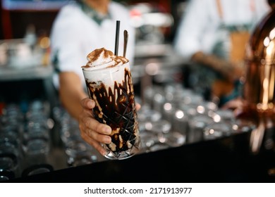 Close Up Of Female Cafeteria Worker Serving Iced Coffee With Whipped Cream.