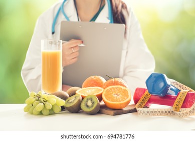 Close up of a Female Dietician With Fresh Vegetables and fruits - Powered by Shutterstock