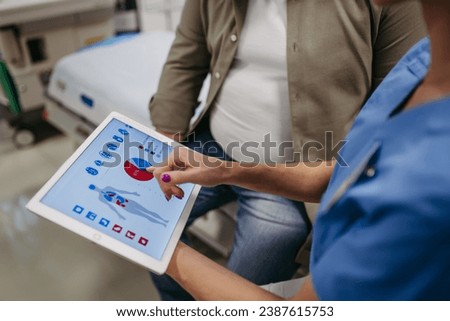 Close up of female doctor consulting with overweight patient, discussing test result in doctor office. Showing medical report on tablet. Obesity affecting middle-aged men's health. Concept of health