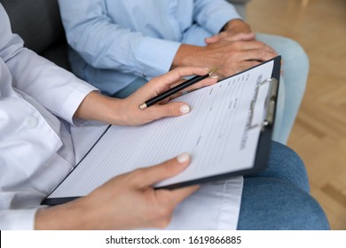 Close up female doctor holding clipboard, filling older patient form, documents, medical history or anamnesis, disease prevention, healthcare, health insurance contract, mature woman checkup - Powered by Shutterstock