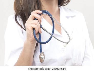 close up of female doctor holding a stethoscope in her right hand. studio shot.