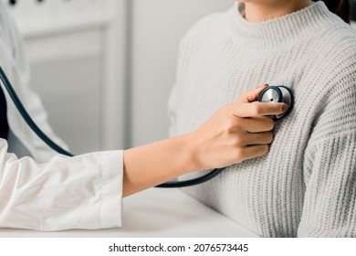 Close up of Female Doctor using stethoscope putting beat heart diagnose with patient in examination room at a hospital, check-up body, Medical and Health Care Concept.