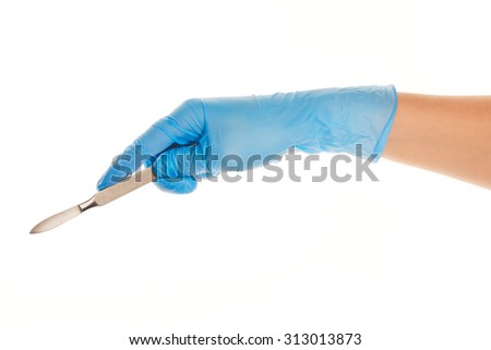 Close up of female doctor's hand in blue sterilized surgical glove with scalpel against white background