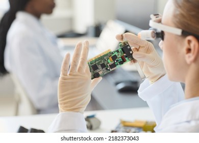 Close Up Of Female Engineer Inspecting Electronic Parts In Laboratory, Copy Space