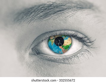 Close up of female eye with Earth planet. Elements of this image are furnished by NASA