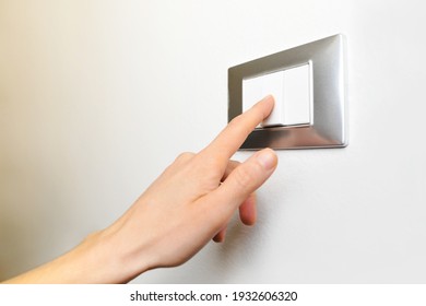 Close Up Of Female Finger Is Turn Off On Lighting Switch At Home. Power, Energy, Saving Electrical, Copy Space.