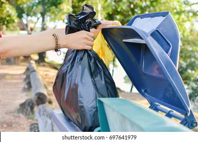 Close Up Female Hand Holding Bin Bag Into The Trash