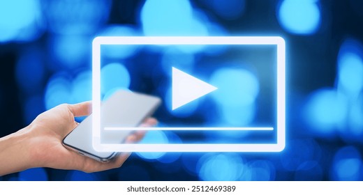 Close up of female hand holding cellphone with glowing play button on blurry bokeh background. Technology and digital entertainment concept - Powered by Shutterstock