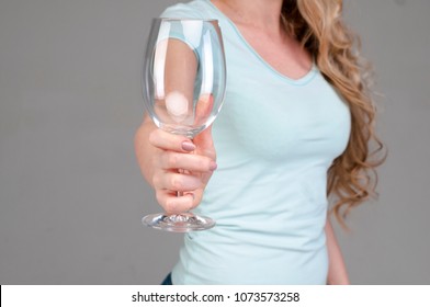 Close Up Of Female Hand Holding Empty Clean Transparent Wine Glass