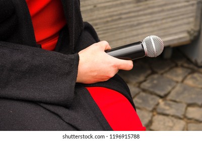 Close Up Female Hand Holding Microphone. Reporter Interviewing Outdoors. The Concept To Speak, Record With The Microphone, To Interview, The Press, TV