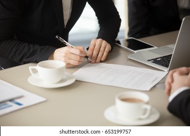 Close up of female hand holding pen, about to sign official paper, putting signature on legal document, ink deal, enter conclude contract for services, work and supplies, bilateral basic agreement  - Shutterstock ID 653199757