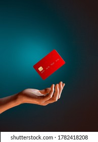 Close up female hand holds levitating template mockup Bank credit card with online service isolated on blue background