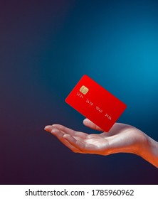 Close up female hand holds levitating template mockup Bank credit card with online service isolated on blue background